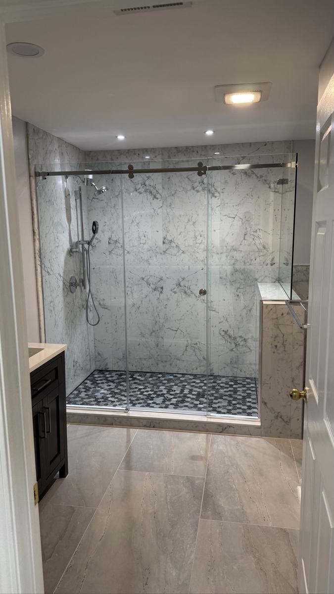 Frameless corner shower enclosure with single sliding door and chrome hardware